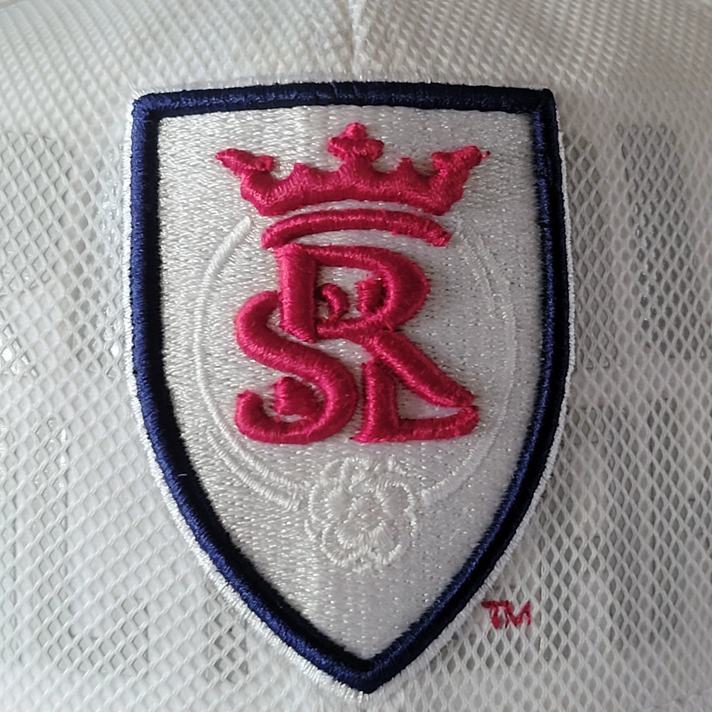 a white hat with a red and blue logo on it