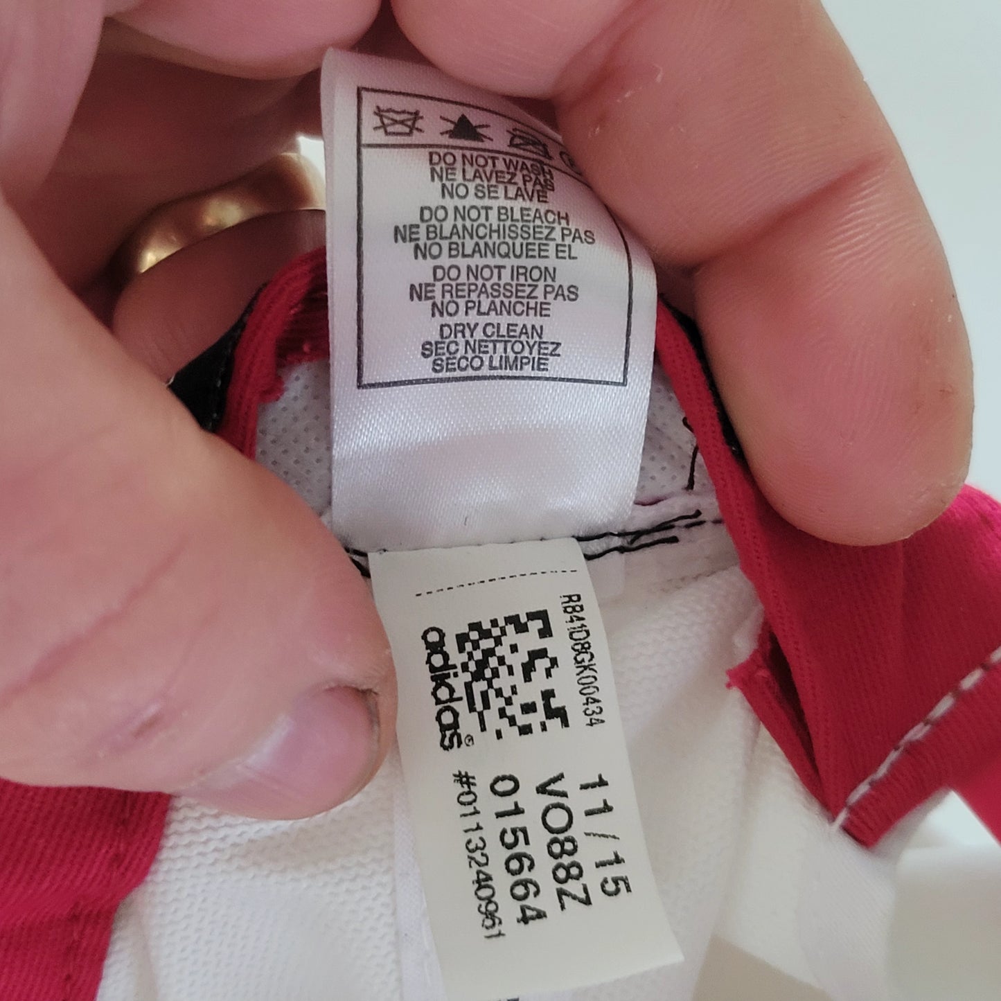 a person holding a label on a white shirt