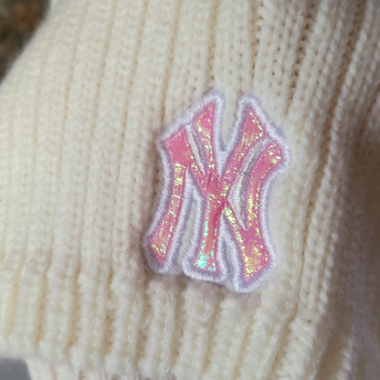 a close up of a knitted hat with a sequined new york yankees