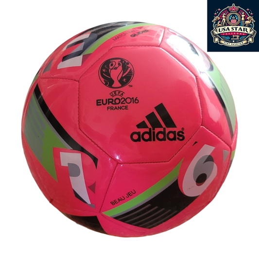 a pink soccer ball with black and green stripes