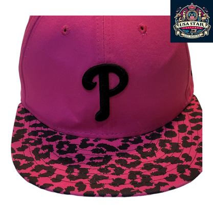 a pink hat with a black p on it