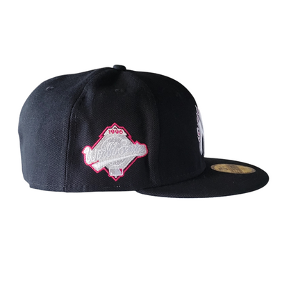 a black hat with pink embroidery on it