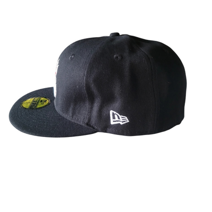 a new era hat with a yellow patch on the side