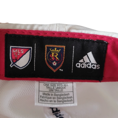 a red and white jersey with three different logos on it