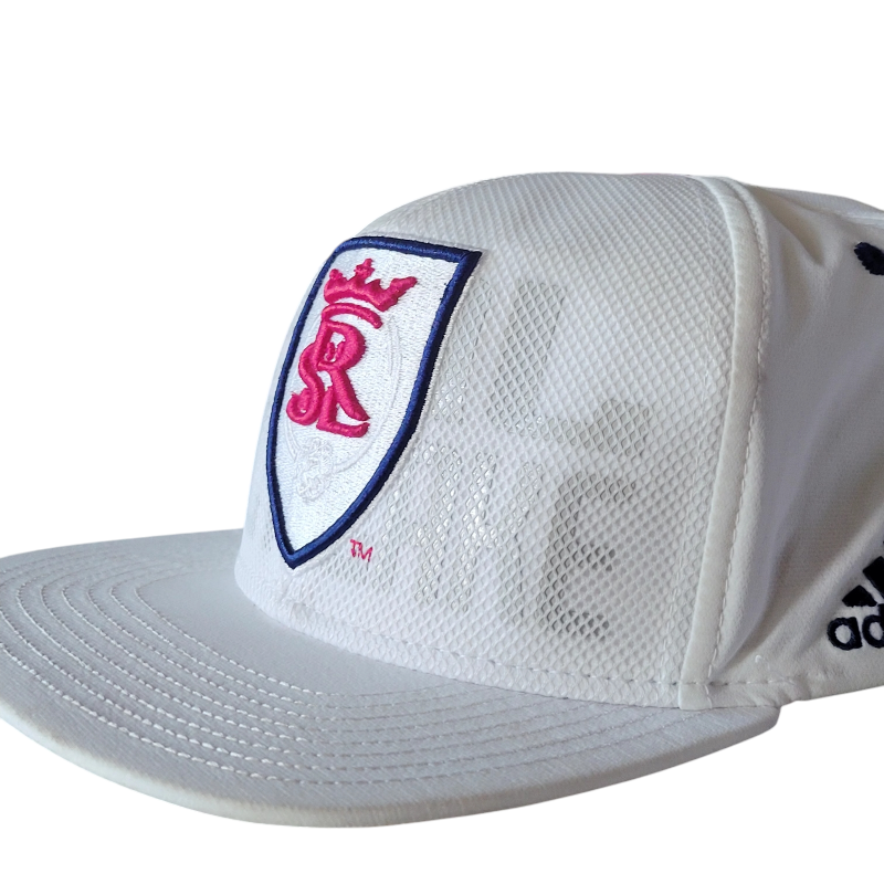 a white hat with a red and blue crest on it