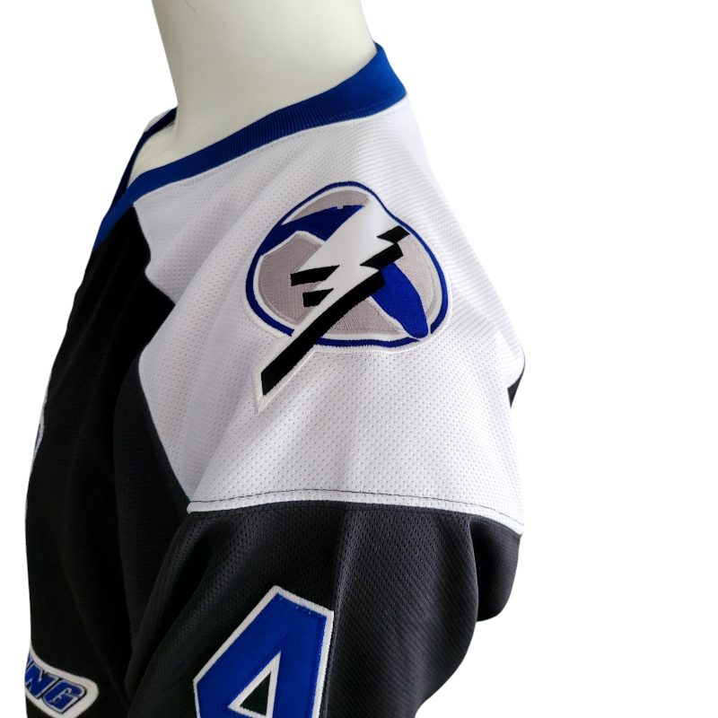 a white and blue hockey jersey on a mannequin